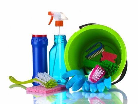 Cleaner working in a Wandsworth living room with local property details in view
