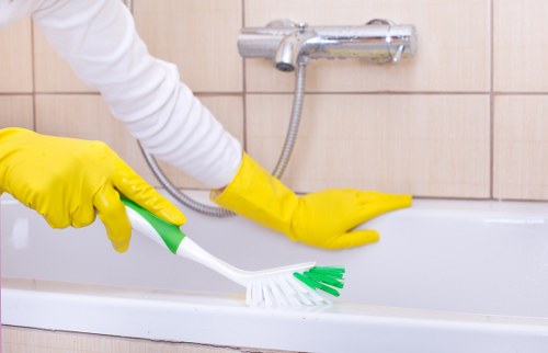 Technician carrying out upholstery cleaning on a fabric sofa